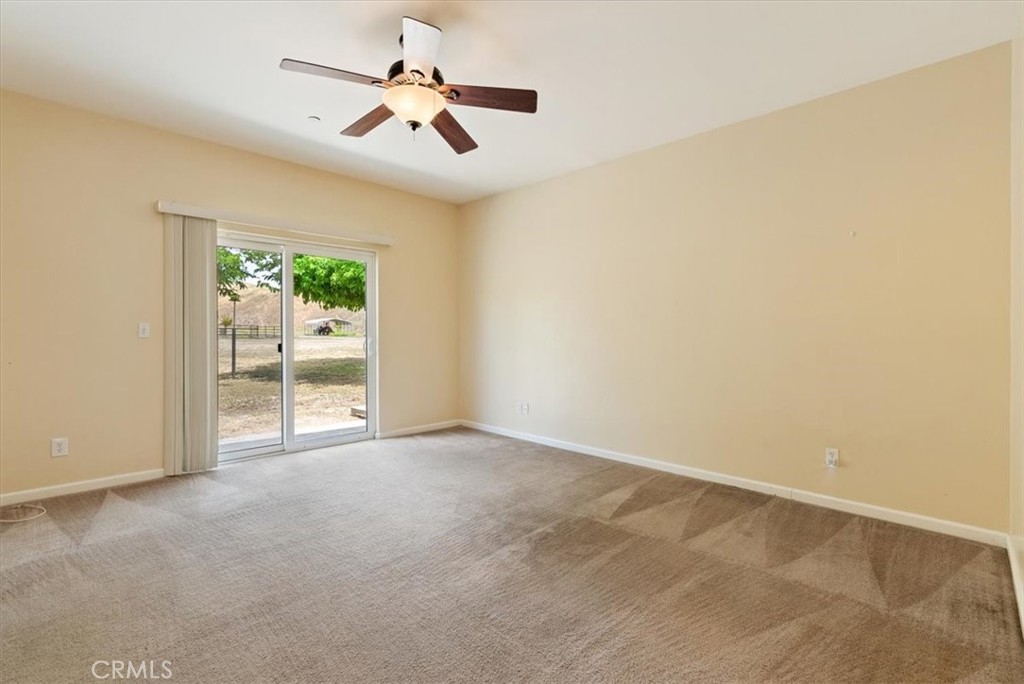 76846 Ranchita Canyon Road San Miguel, CA 93451 - Photo 21 of 51 an empty room with windows and ceiling fan