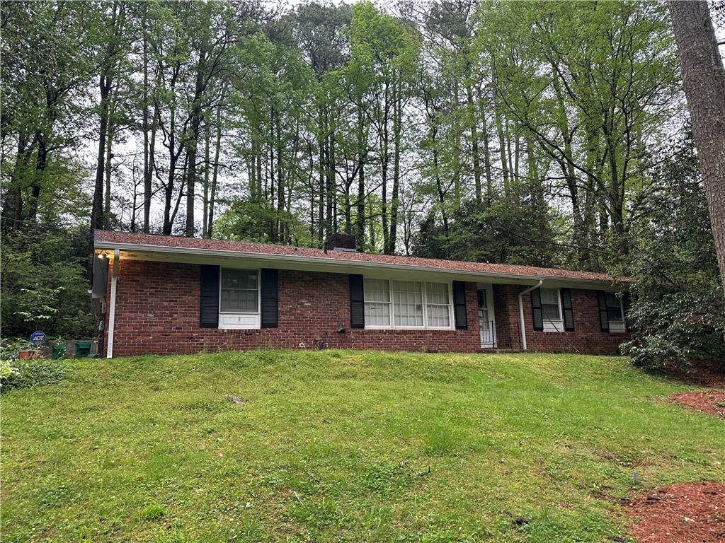 a view of a brick house with a yard