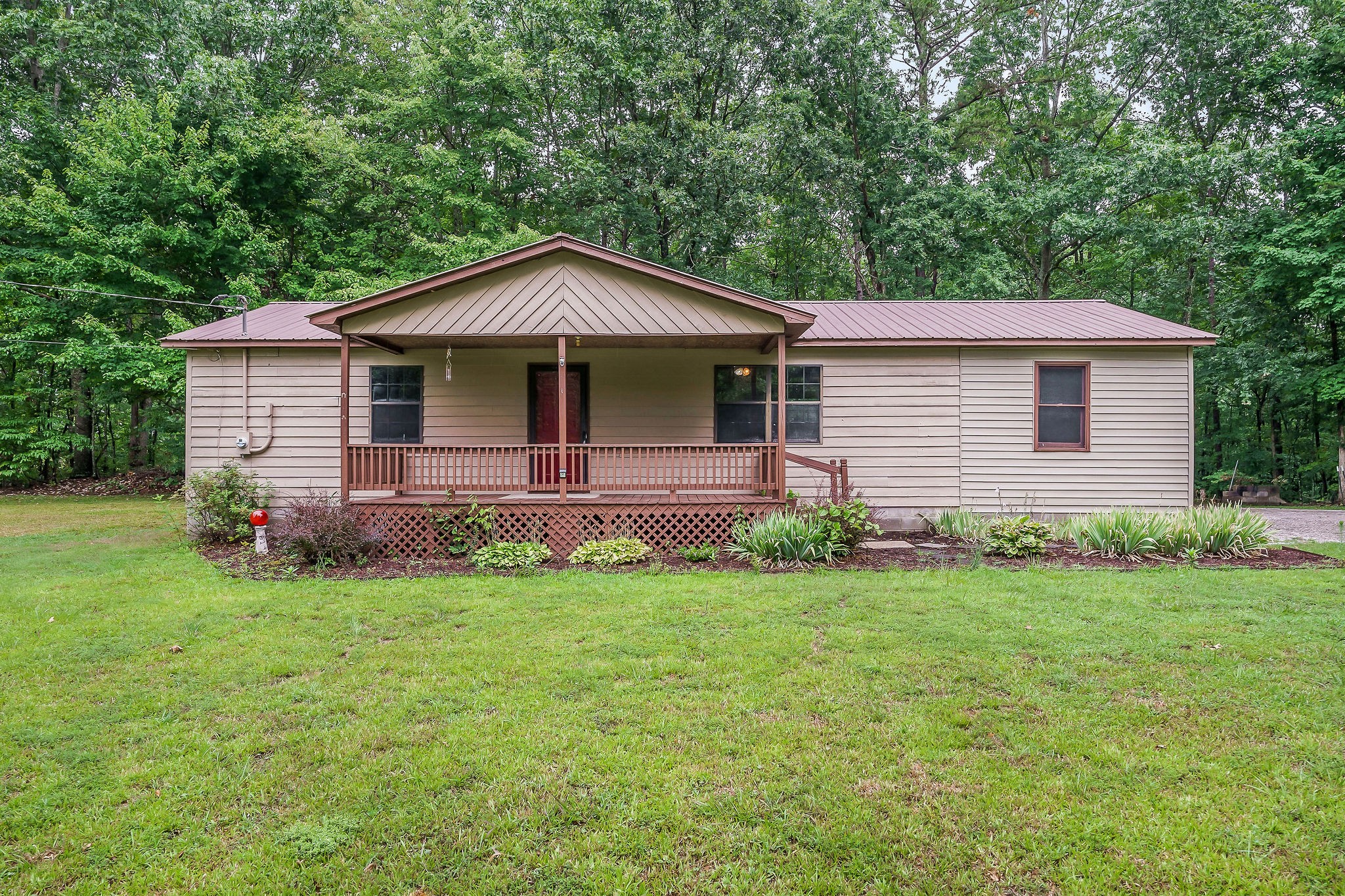 569 Robs Road Grimsley, TN 38565 - Photo 23 of 40 a front view of a house with a garden