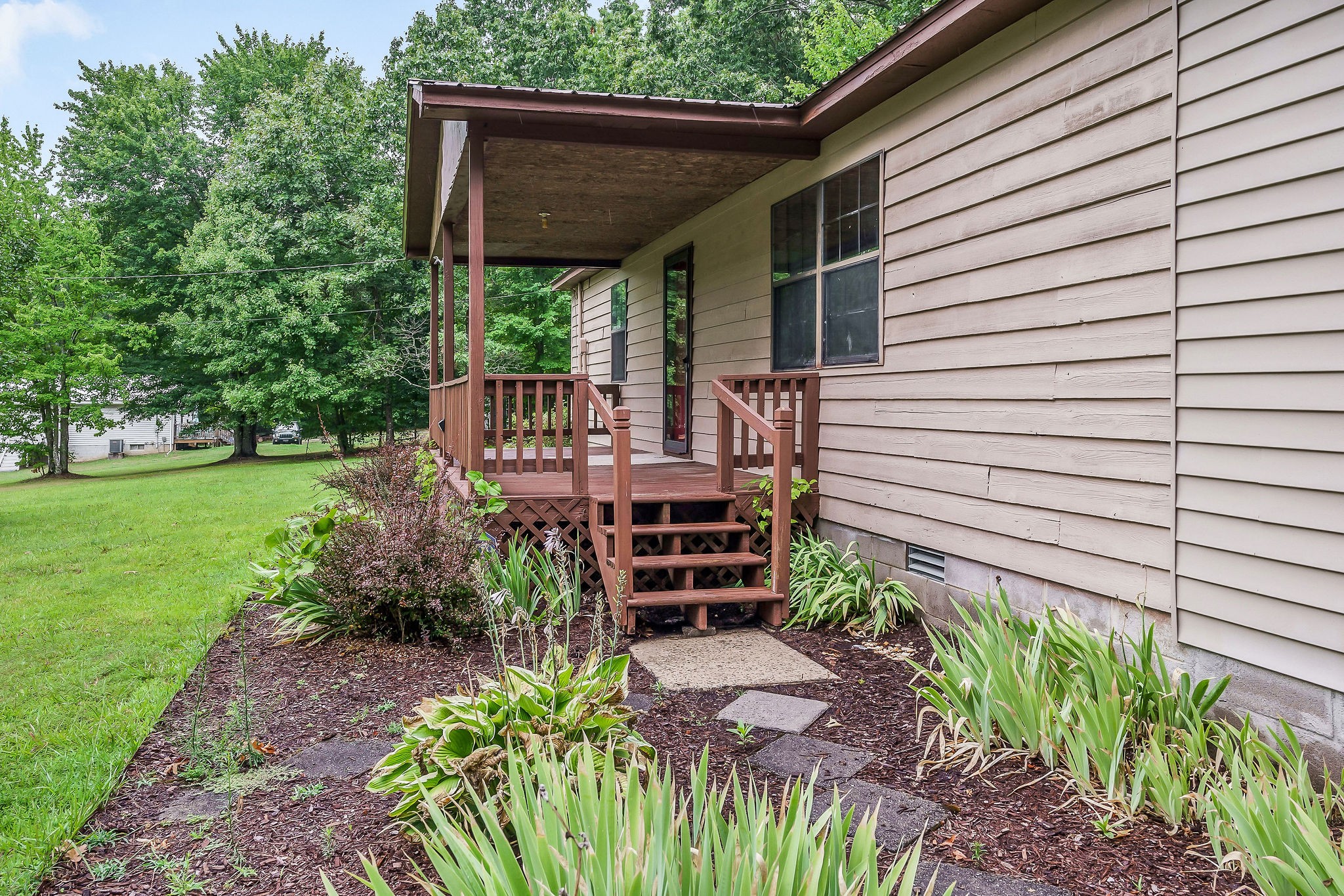 569 Robs Road Grimsley, TN 38565 - Photo 24 of 40 a view of a backyard with plants and large tree