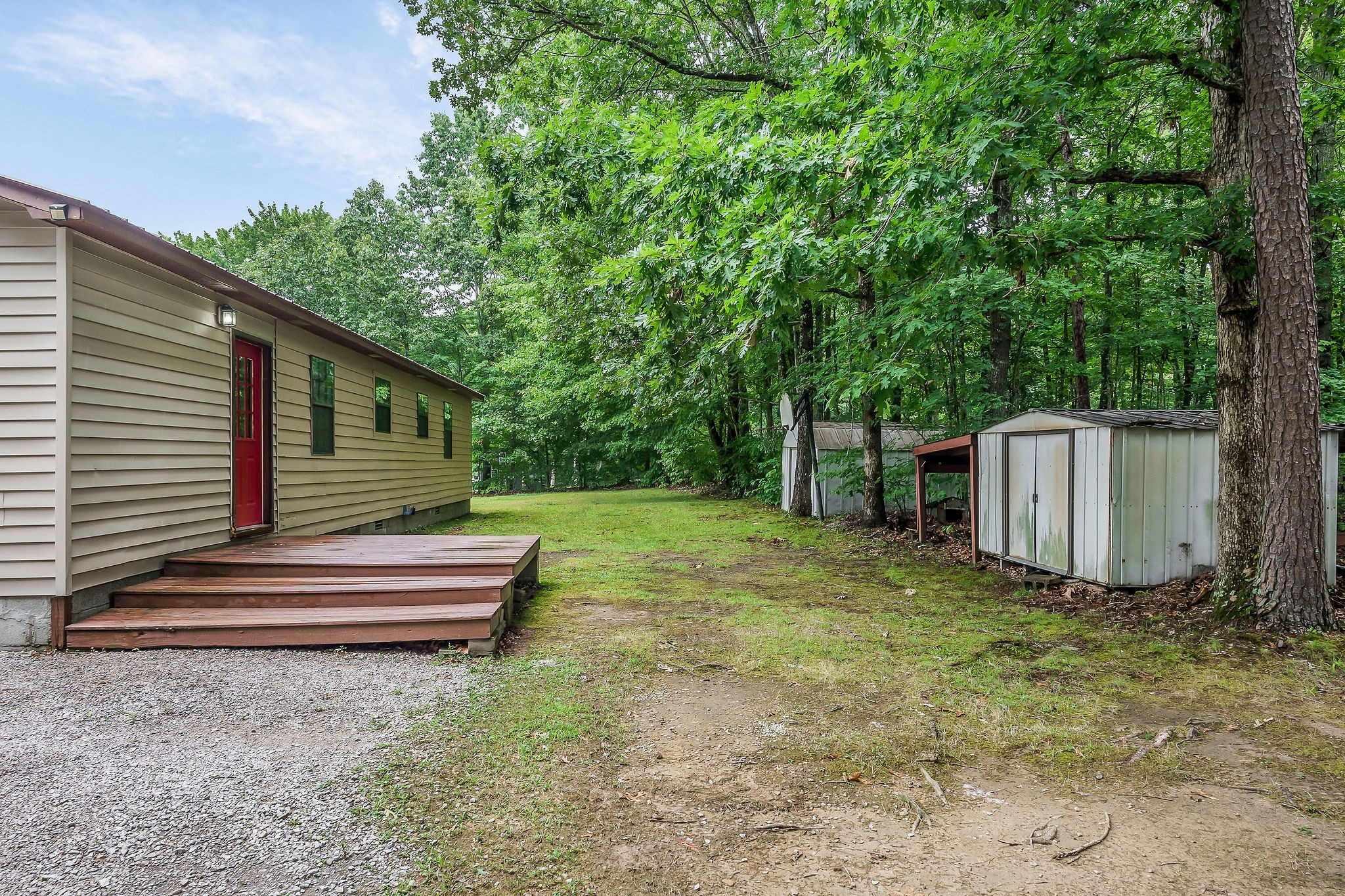 569 Robs Road Grimsley, TN 38565 - Photo 27 of 40 a backyard of a house with a large tree and wooden fence