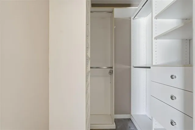 a living room with furniture a flat screen tv and kitchen view