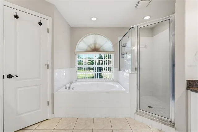 an empty room with windows and chandelier