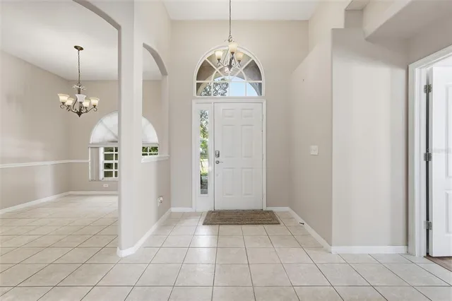 a bathroom with a granite countertop sink vanity mirror and toilet