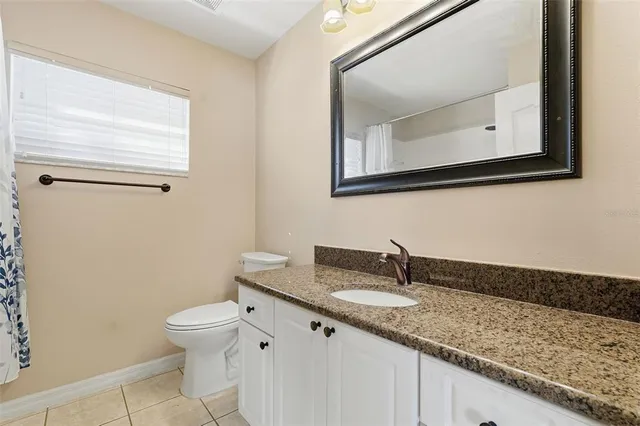 a view of a dining room with furniture and a kitchen