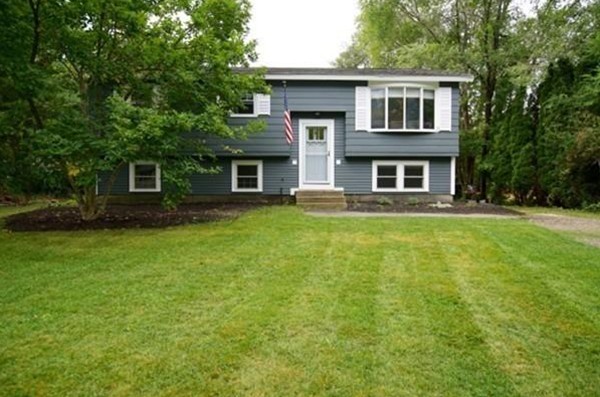 54 Forest Road Salisbury, MA 01952 - Photo 1 of 17 a front view of a house with a garden