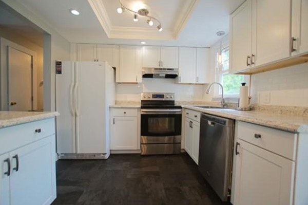 54 Forest Road Salisbury, MA 01952 - Photo 4 of 17 a kitchen with stainless steel appliances white cabinets and a refrigerator