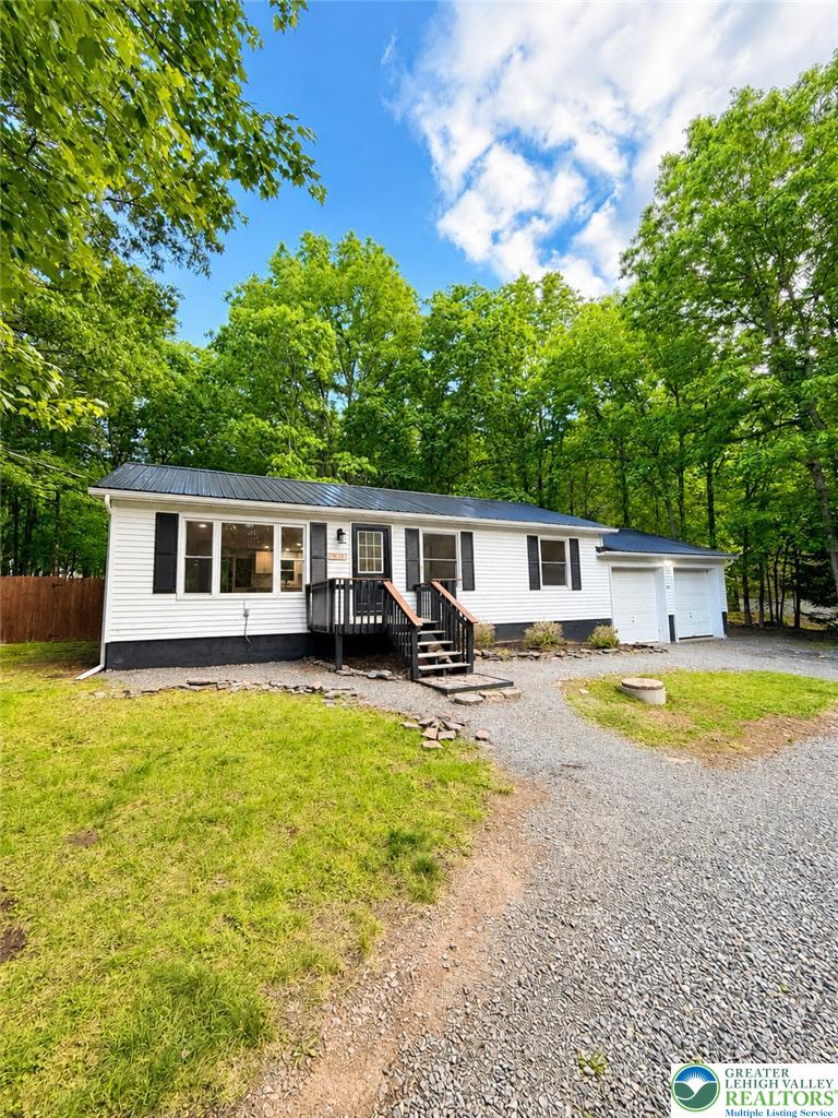 182 Mountain Road Albrightsville, PA 18210 - Photo 1 of 17 A well-maintained residence nestled among mature trees with a convenient attached garage.
