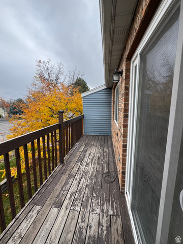 608 South 500 West, Unit 3 Provo, UT 84601 - Photo 34 of 35 Exterior balcony featuring a brick facade, wood railing, and vinyl siding