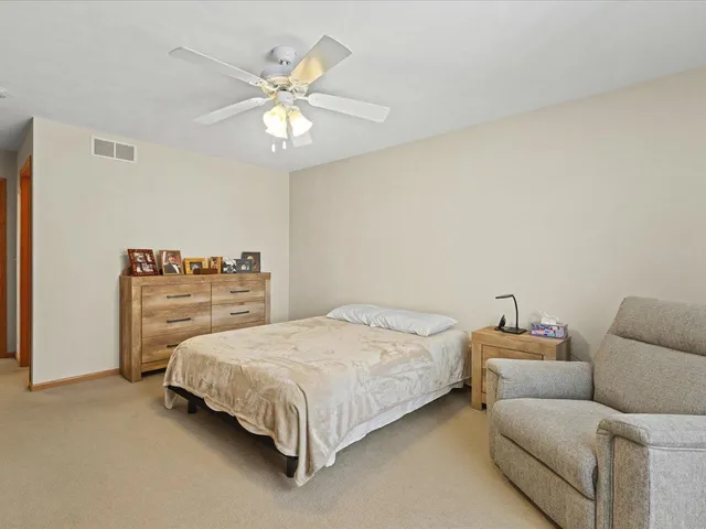 a bedroom with a bed and a couch