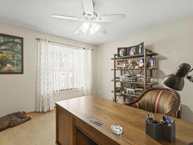 a view of workspace with furniture and chandelier
