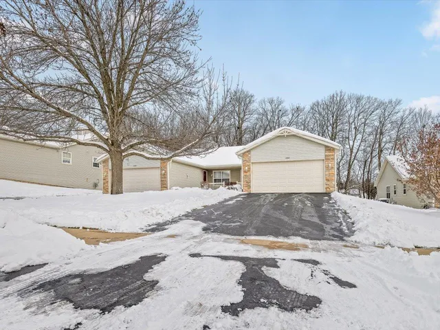 a view of a house with snow on the road