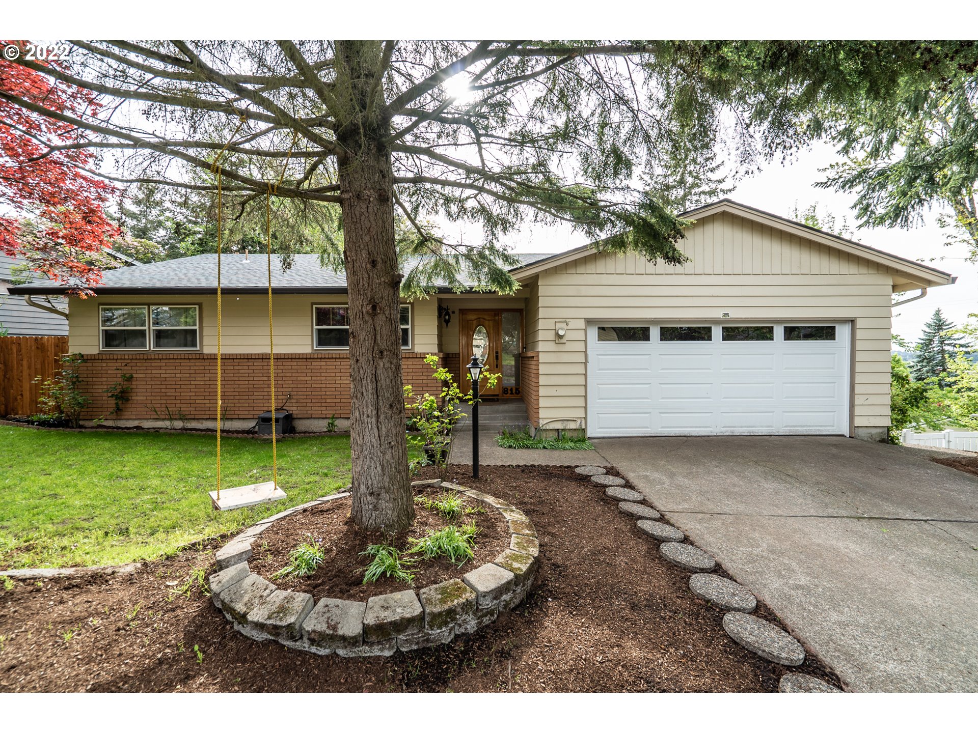 815 Northwest Mawrcrest Drive Gresham, OR 97030 - Photo 1 of 30 a front view of a house with a yard and garage