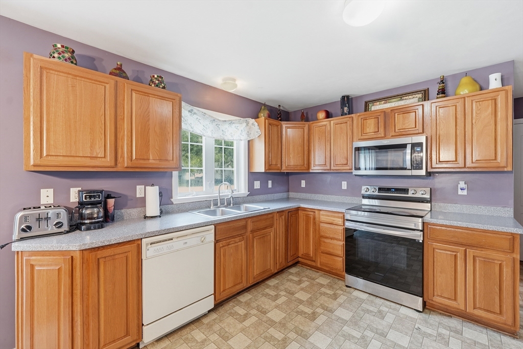 19 Annies Way Springfield, MA 01119 - Photo 9 of 40 a kitchen with stainless steel appliances granite countertop a sink stove and microwave