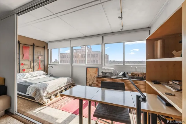 a living room with furniture and a book shelf