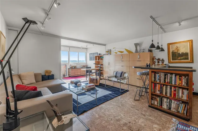 a room with furniture pool table and window