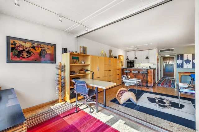 a living room with furniture and wooden floors