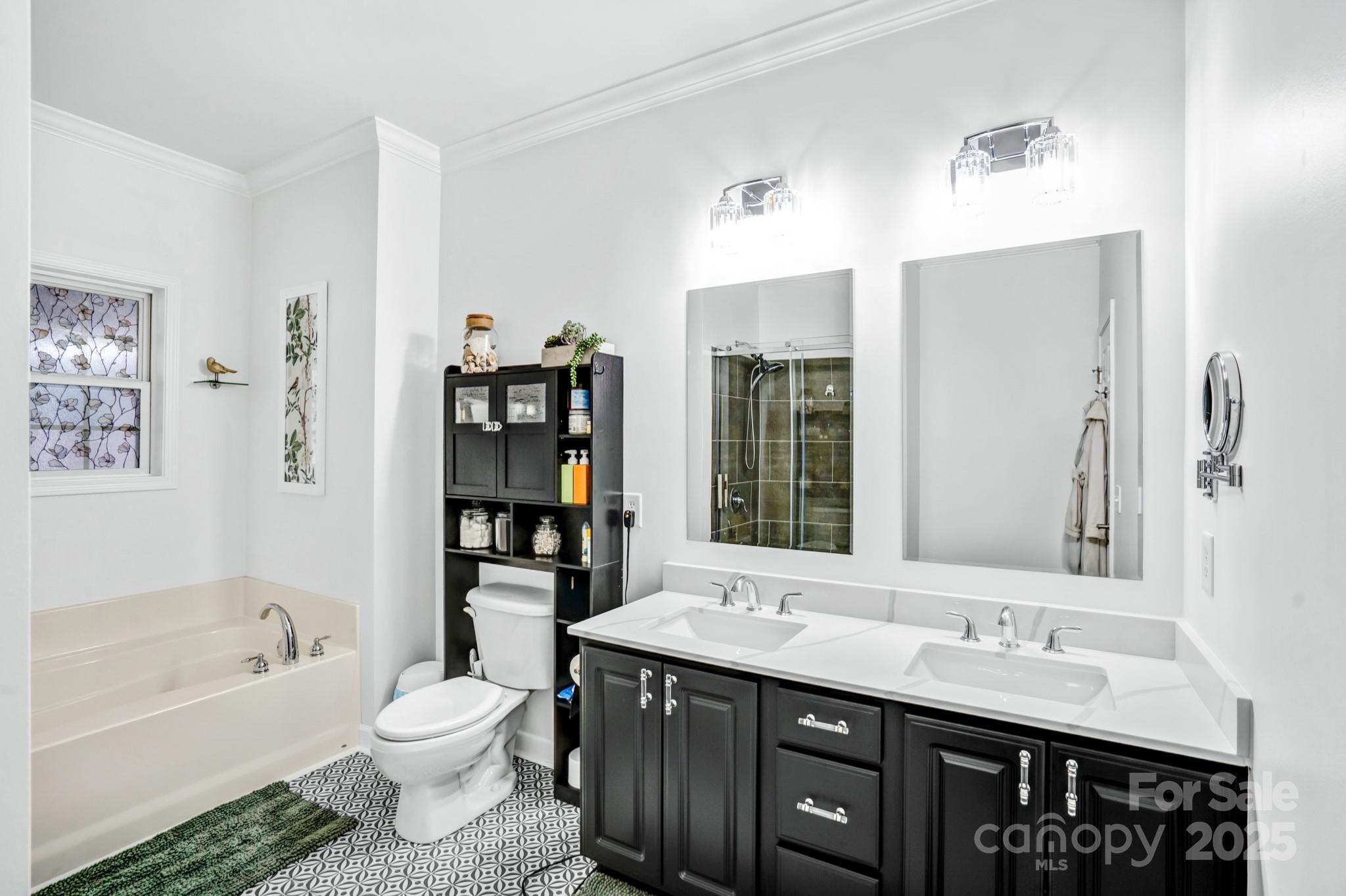 165 Kimball Loop China Grove, NC 28023 - Photo 25 of 48 a bathroom with a toilet a double vanity sink and a bathtub