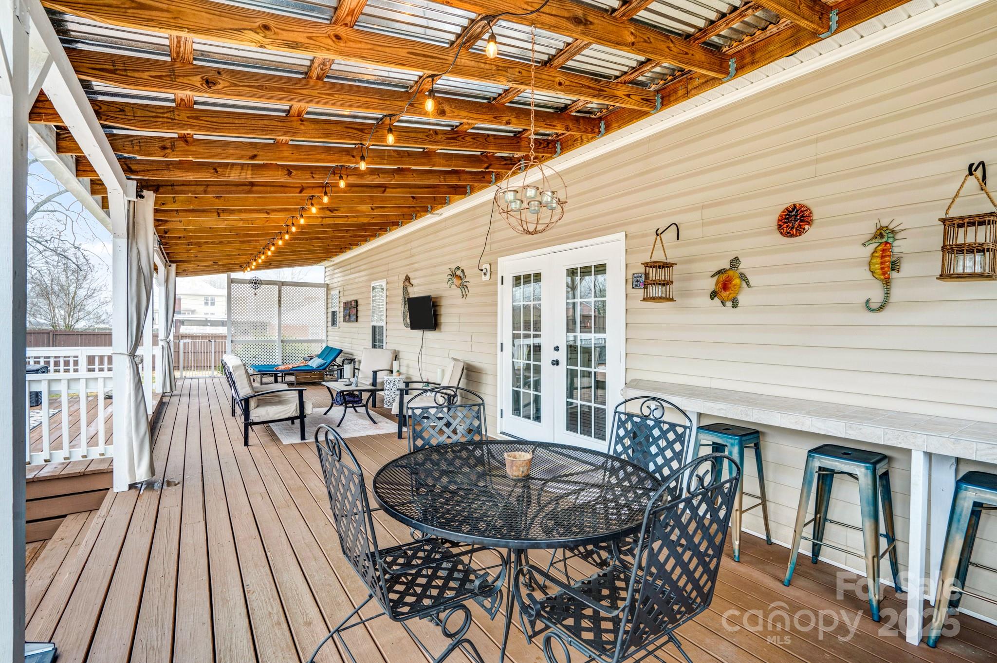 165 Kimball Loop China Grove, NC 28023 - Photo 39 of 48 a view of a patio with table and chairs with wooden floor and fence