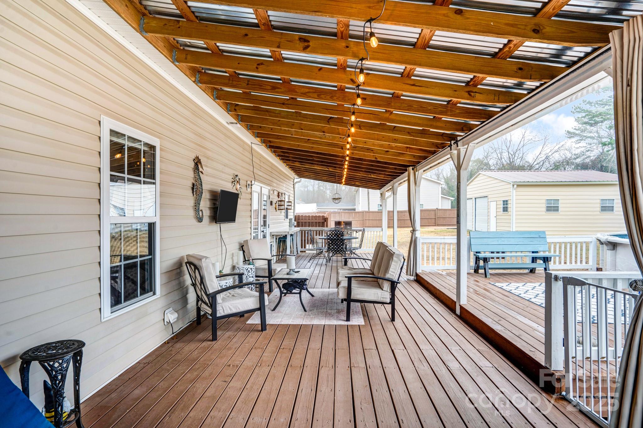 165 Kimball Loop China Grove, NC 28023 - Photo 40 of 48 a view of a patio with table and chairs with wooden floor and fence