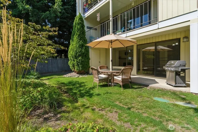 a backyard of a house with yard and outdoor seating