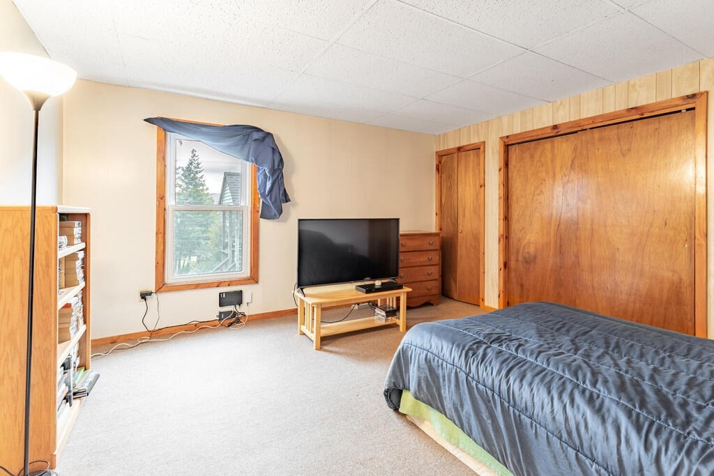 8 Boston Road Sutton, MA 01590 - Photo 18 of 30 a bedroom with a bed and flat screen tv