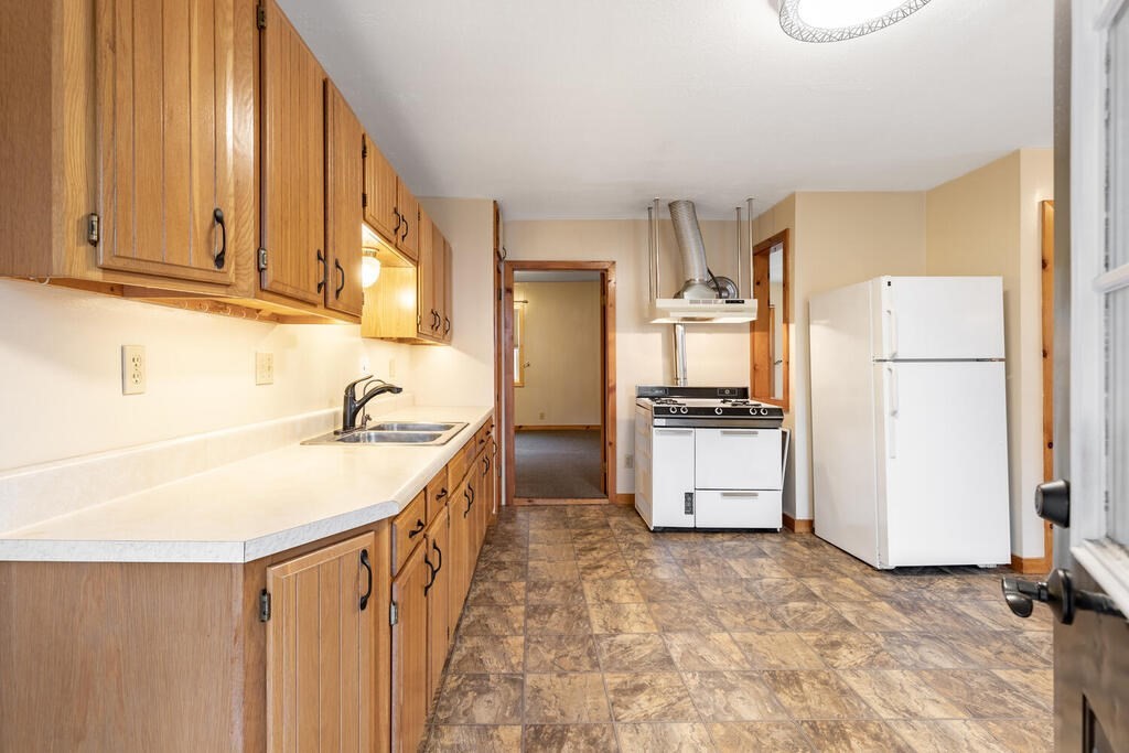 8 Boston Road Sutton, MA 01590 - Photo 20 of 30 a kitchen with a sink stove and refrigerator