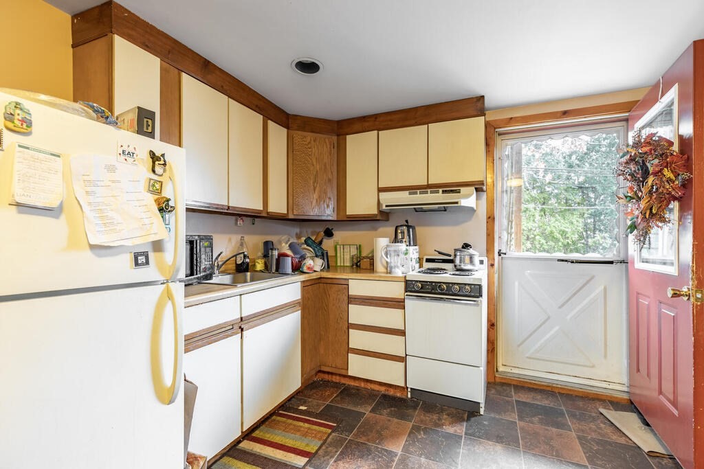 8 Boston Road Sutton, MA 01590 - Photo 5 of 30 a kitchen with stainless steel appliances white cabinets and a stove top oven
