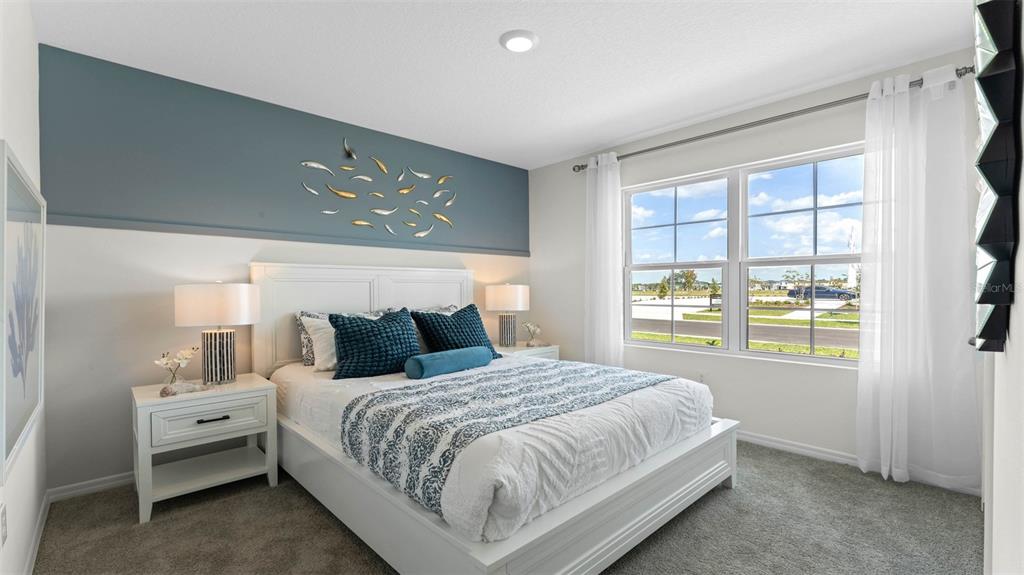 2851 House Finch Road St. Cloud, FL 34773 - Photo 13 of 52 a bedroom with a large bed and a window