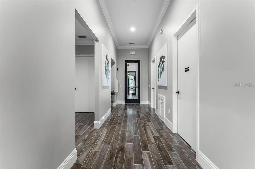 2851 House Finch Road St. Cloud, FL 34773 - Photo 18 of 52 a view of a hallway with wooden floor