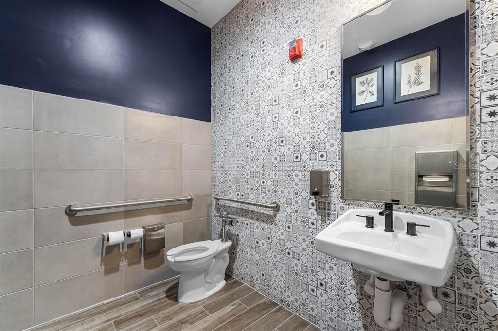 2851 House Finch Road St. Cloud, FL 34773 - Photo 19 of 52 a bathroom with a toilet a sink and mirror