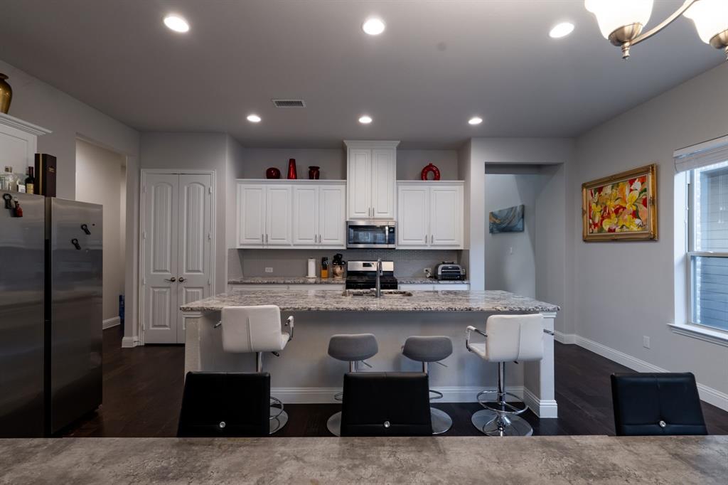 3612 Elizabeth Street Rowlett, TX 75088 - Photo 12 of 23 a large kitchen with stainless steel appliances granite countertop a stove and a refrigerator