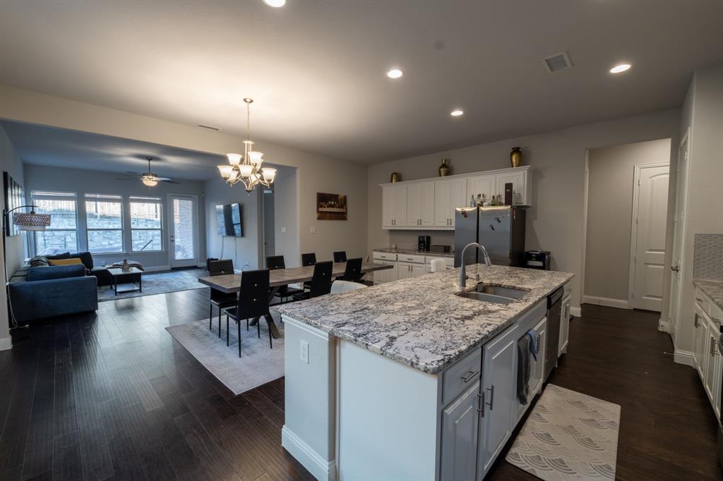 3612 Elizabeth Street Rowlett, TX 75088 - Photo 8 of 23 an open kitchen with a table and chairs in it
