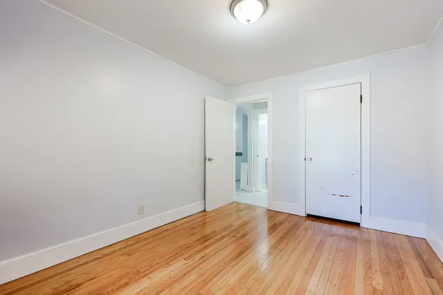 a view of a room with wooden floor