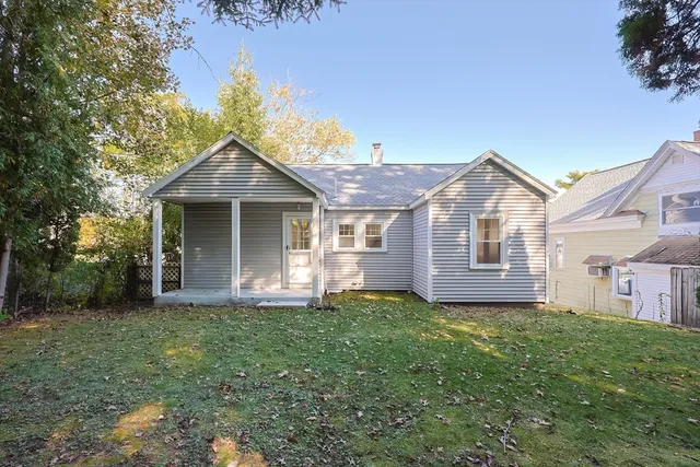 a front view of a house with a garden