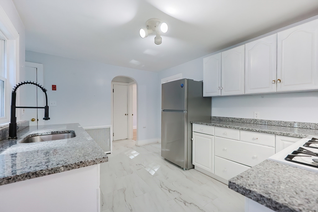 37 Maplewood Avenue Methuen, MA 01844 - Photo 10 of 42 a kitchen with stainless steel appliances granite countertop a sink stove and refrigerator