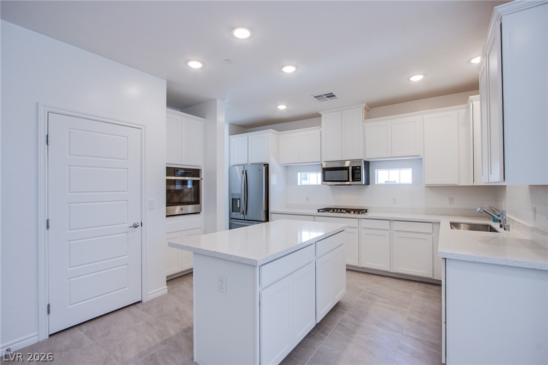 2555 Hampton Road, Unit 11201 Henderson, NV 89052 - Photo 11 of 24 Recessed lighting illuminates clean lines and modern surfaces throughout this culinary space.