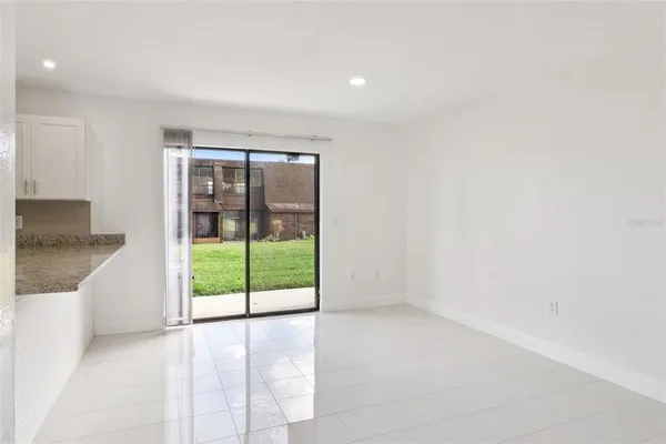 a view of an empty room with a kitchen