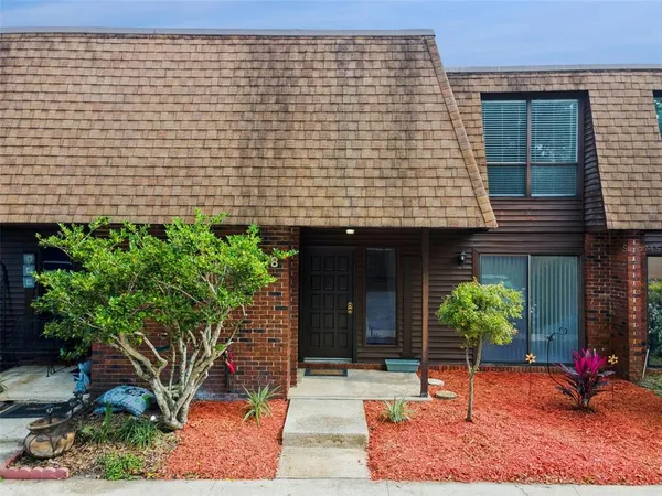 a front view of a house with plants