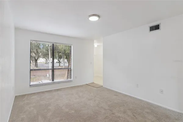 an empty room with windows and closet