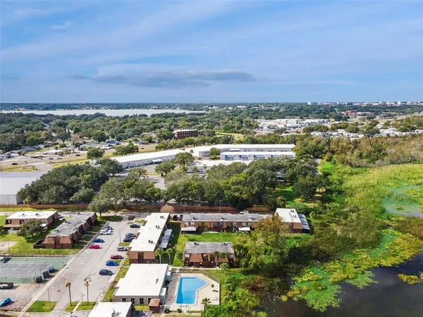 an aerial view of a city with lots of residential buildings and mountain view in back