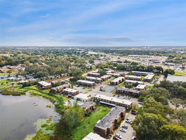 an aerial view of a city with lots of residential buildings and mountain view in back