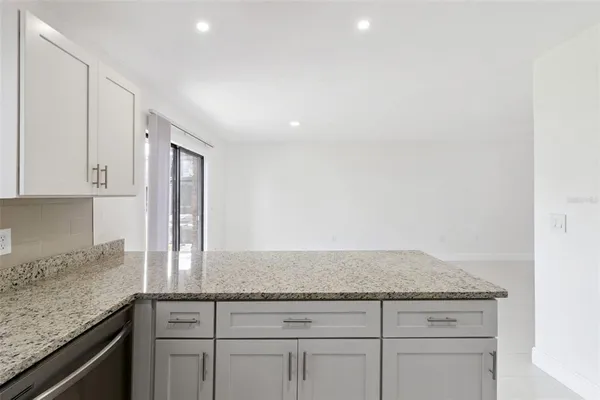 a kitchen with granite countertop white cabinets and a granite counter tops
