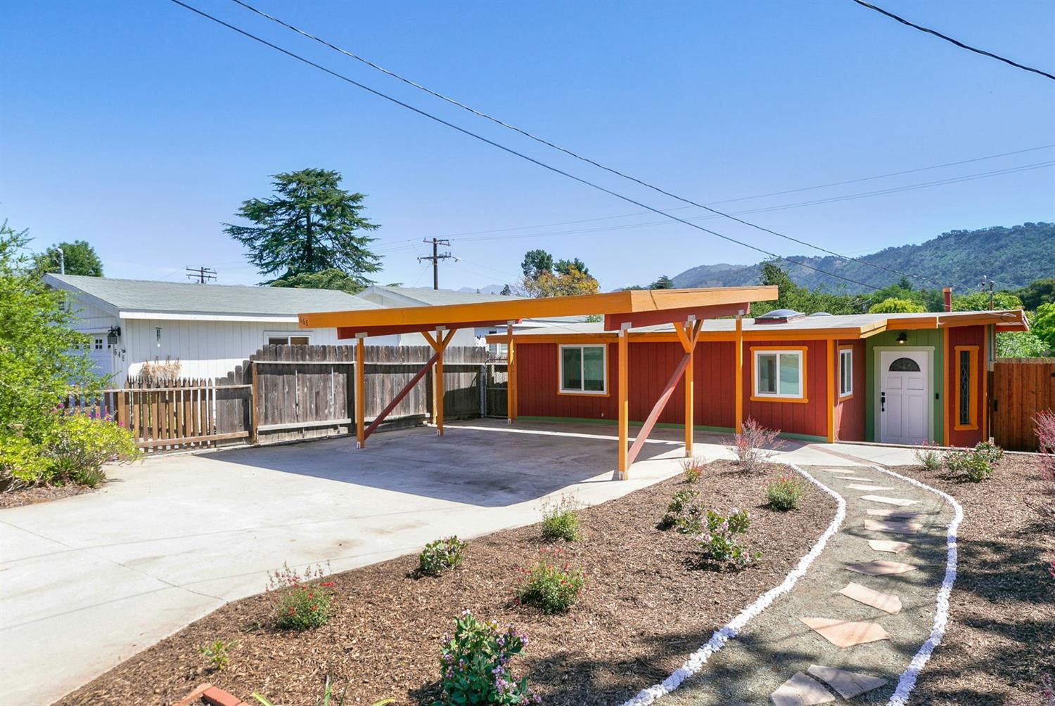 a view of a house with wooden fence