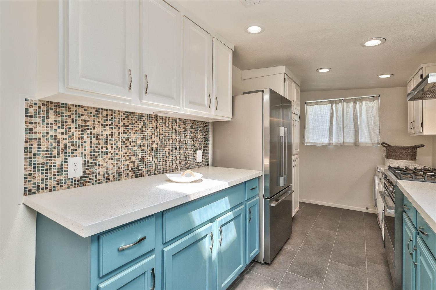 668 Spring Street Oak View, CA 93022 - Photo 12 of 24 a kitchen with a sink stove and refrigerator