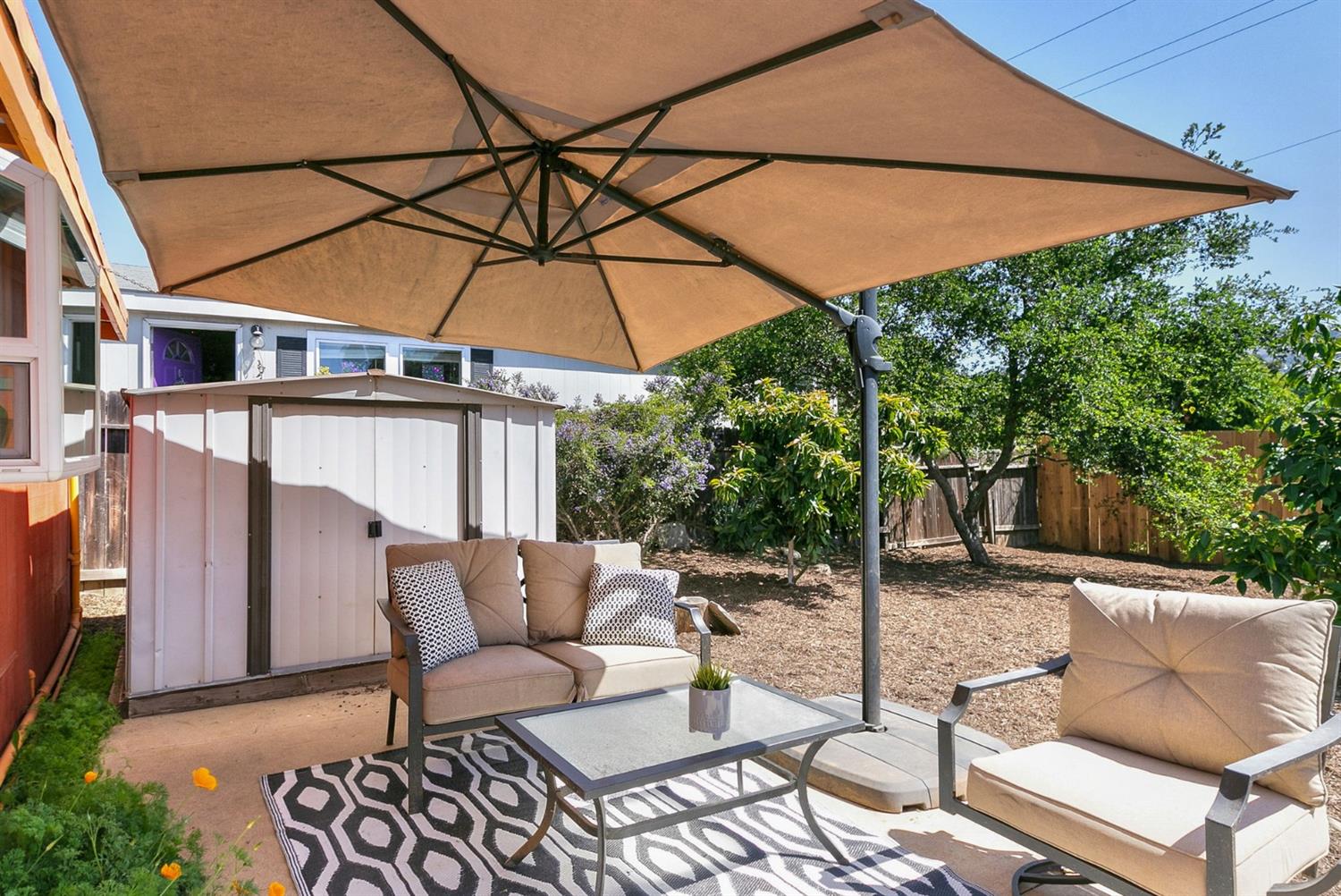 668 Spring Street Oak View, CA 93022 - Photo 19 of 24 a patio with a table and chairs under an umbrella