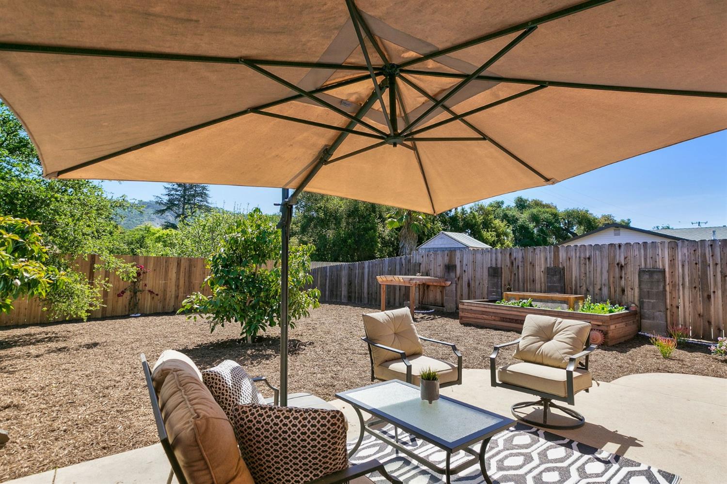 668 Spring Street Oak View, CA 93022 - Photo 20 of 24 a patio with patio a table and chairs under an umbrella