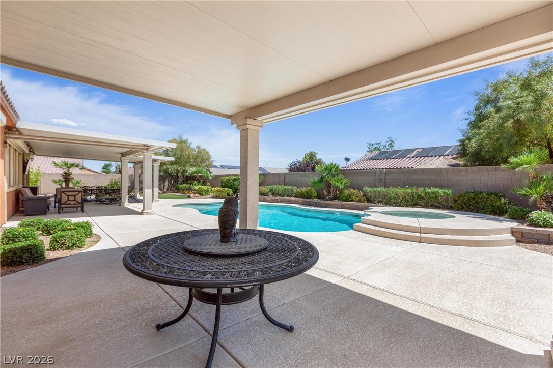 8431 Durango Ranch Court Las Vegas, NV 89113 - Photo 38 of 49 Relax in this inviting backyard oasis, featuring a pristine pool and covered patio.