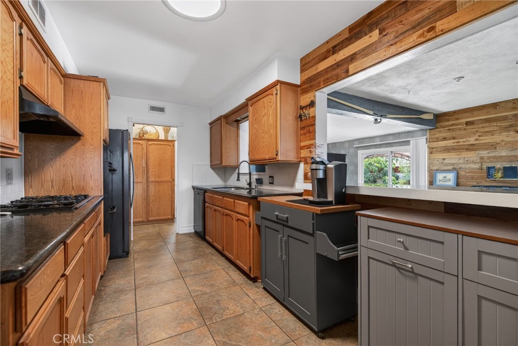 4194 Euclid Court Riverside, CA 92504 - Photo 9 of 29 Updated kitchen with large pass-through to the bonus room, convenient for chatting with guests while they are shooting pool.