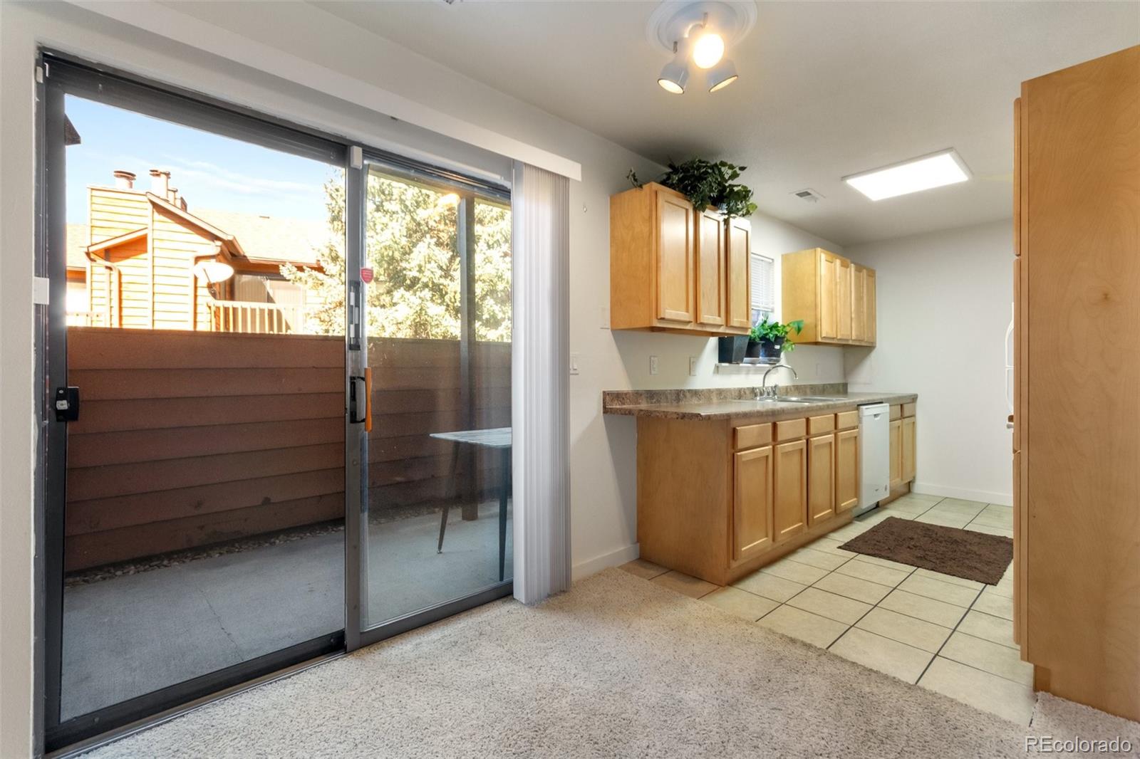 2265 South Buckley Road, Unit 102 Aurora, CO 80013 - Photo 11 of 28 a kitchen with a sink window and cabinets